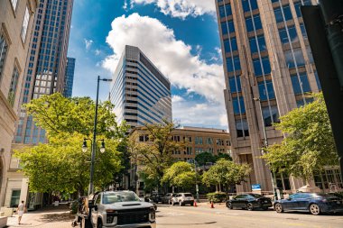 Charlotte, Kuzey Carolina 'nın iş bölgesi. Gökdelenleri ve mavi gökyüzünün altındaki yollarda arabaları var. Düşük bir açıdan ateş edilmiş. .