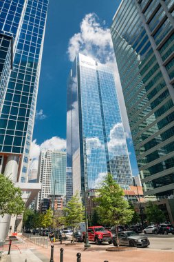 High-rise mirrored buildings reach for the clouds in the thriving business district of Charlotte, North Carolina clipart