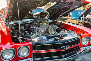 Red Chevy Chevrolet Chevelle SS retro race car with a boosted engine. clipart