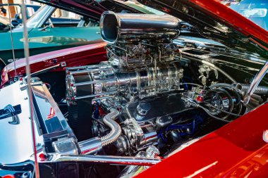 boosted or turbocharged engine under the hood of a Chevy Chevrolet Chevelle SS retro race car.  clipart