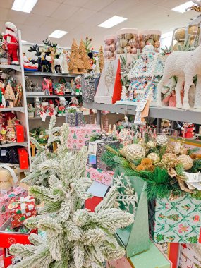 Christmas trees and gifts on shelves in supermarket. Shelves with Christmas decorations in a department store. Shopping concept clipart