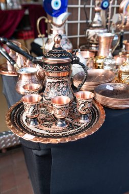 Copper Turkish Turkish cookware jezvahs, pitchers and teapots at a fair in Baltimore, Maryland, clipart