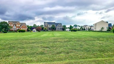 Neighborhood of detached homes with large lawns. Modern single-family homes. clipart