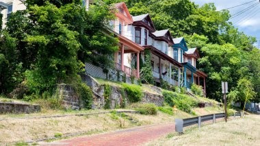 Vintage timber townhouses with paved sidewalk in Cumberland, Moreland. clipart