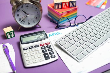 Tax filing deadline. a computer and calculator on a desk, a TAX sign and a clock. clipart