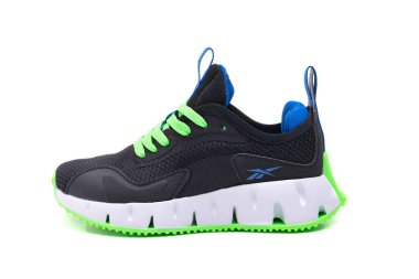 Black reebok running sneakers with bright green sole. clipart