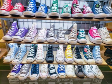 Bir mağazanın raflarında Converse 'in renkli ayakkabıları var..