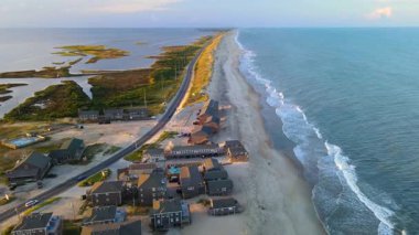 Gün batımında Cape Hatteras 'ta. Atlantik Okyanusu kıyıları, oteller, villalar ve sahil boyunca uzanan yollar..