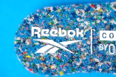 Spor ayakkabılarının yumuşak tabanındaki Reebok logosuna yakın plan..