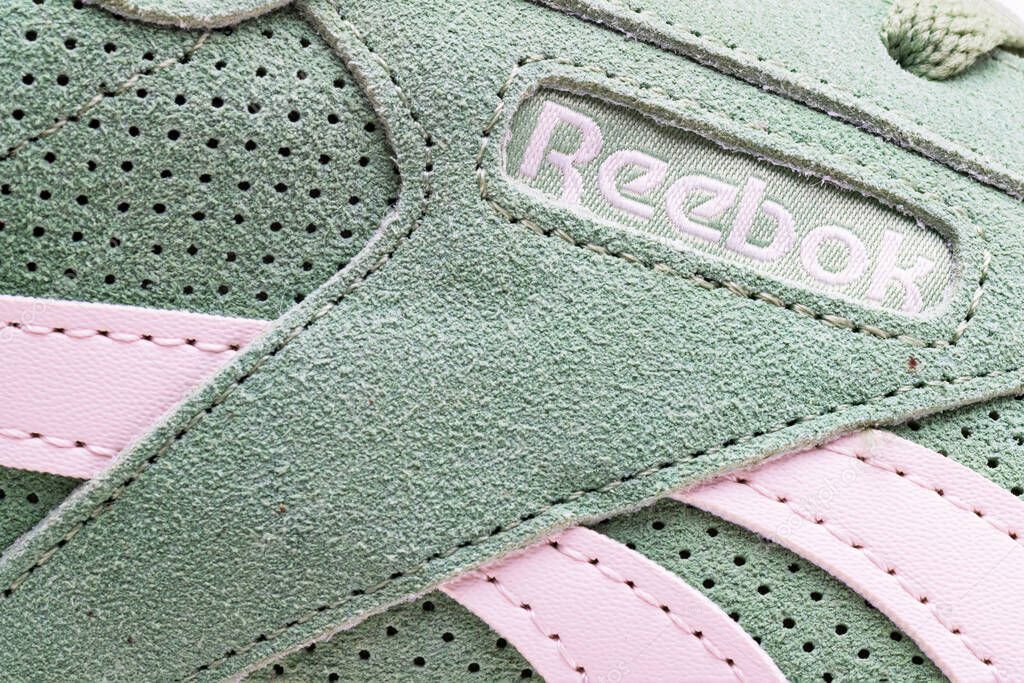 Turquoise suede sneakers. Reebok inscription close-up.