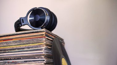 Kulaklıklar vinil yığını üzerinde. Bir karede zamansız müzik.