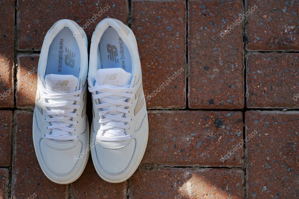 White leather New Balance sneakers top view. Athletic casual shoes.