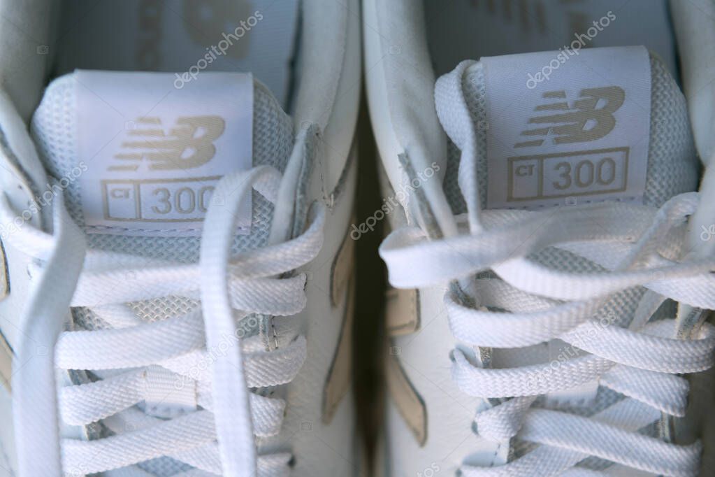 Lacing and emblem on New Balance sneaker. Close-up of the logo.