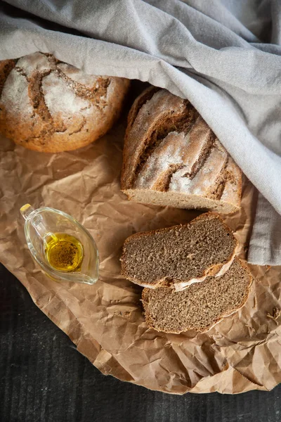 自家製ライ麦パン リネンナプキンとクラフト紙のオリーブオイル — ストック写真