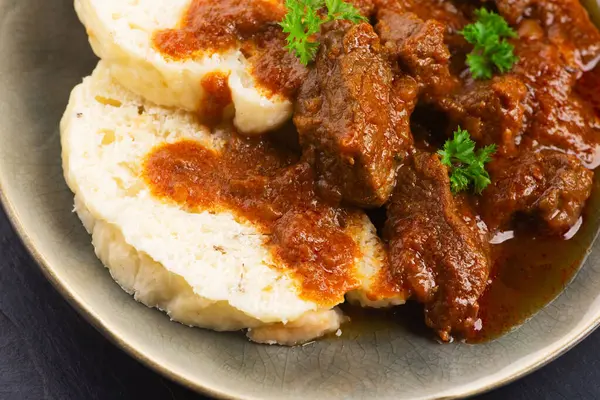 stock image Beef goulash and dumplings (knedliky) on table