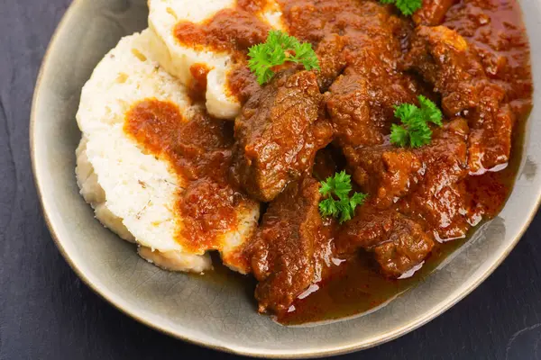 Stock image Beef goulash and dumplings (knedliky) on table