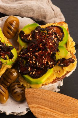 Delicious sandwich with avocado, hummus and carmelized shitake mushroom clipart