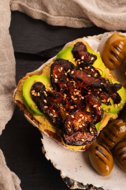 Delicious sandwich with avocado, hummus and carmelized shitake mushroom clipart