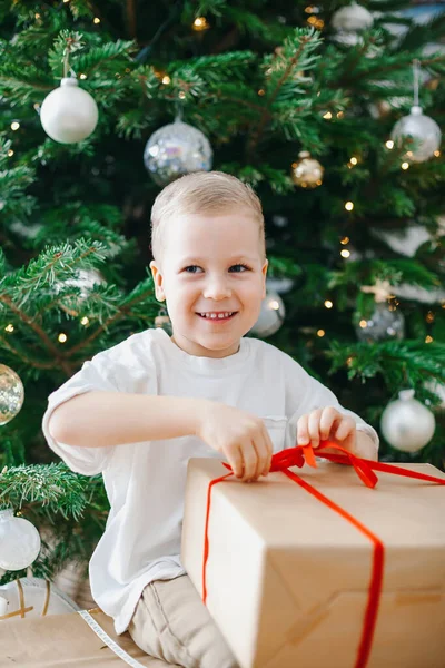 Smiling Little Boy Untying Bow Big Gift Box Sitting Christmas — Stock Photo, Image