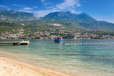 Beautiful view of the small town Herceg Novi in the Bay of Kotor, also known as the Boka, in Montenegro. Sightseeing boat sailing in the bay.