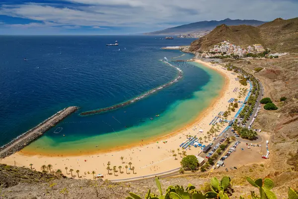 Las Teresitas, Tenerife 'nin manzaralı manzarası, altın kumları, berrak suları ve eğri dalgalı sularıyla eğlence için mükemmel bir kumsal ortamı yaratıyor.