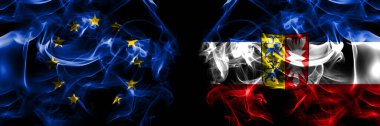 Flags of EU, European Union vs Germany Schleswig Holstein, state. Smoke flag placed side by side on black background. 