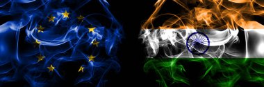 Flags of EU, European Union vs India, Indian. Smoke flag placed side by side on black background. 