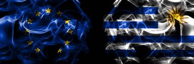 Flags of EU, European Union vs Uruguay, Uruguayan. Smoke flag placed side by side on black background. 