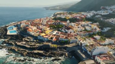 Old town of Garachico on island of Tenerife, Canary. Aerial morning view of Garachico city center with center with colored houses. Ocean shore and lava pools. Popular tourist destination, pearl of the