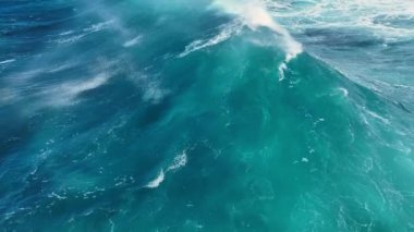 Drone follows big powerful ocean wave. Breaking surf with foam in Atlantic Ocean . Slow motion, aeril view