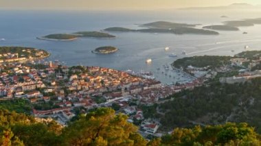Aerial view of Hvar city, Croatia. Hvar island during sunset. Panoramic shot of the island city and Yachts sailing the Adriatic sea. UHD
