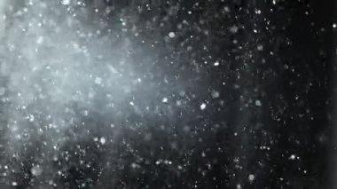Slow motion shot of floating dust particles in the air. Dust in the room with dark background. Air pollution, allergy, difficulty breathing concept. UHD, high quality