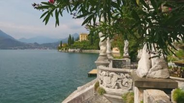 Gimbal shot of famous luxury villa Monastero and botanical garden decorated with mediterranean oleander flowers. Ornamental green park with villa Monastero, lake Como, Varenna, Lombardy region, Italy