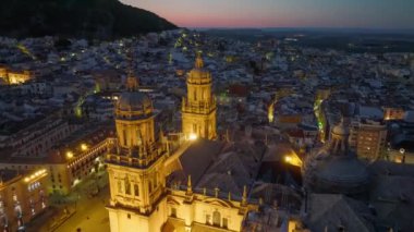 Flying over Jaen Cathedral after sunset, with city lights. Jaen, Andalusia, Spain - evening aerial shot 2