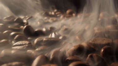 Smoke comes from fresh coffee seeds. Roasting coffee beans with smoke on dark background