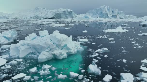 グリーンランドのイルリサット近くの巨大な氷山の上を飛ぶ 海で雪に覆われた氷山の巨大なブロック 地球温暖化と気候変動のコンセプト — ストック動画