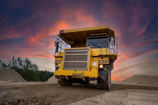 A large quarry dump truck in a coal mine. Loading coal into body work truck. Mining equipment for the transportation of minerals. High quality photo