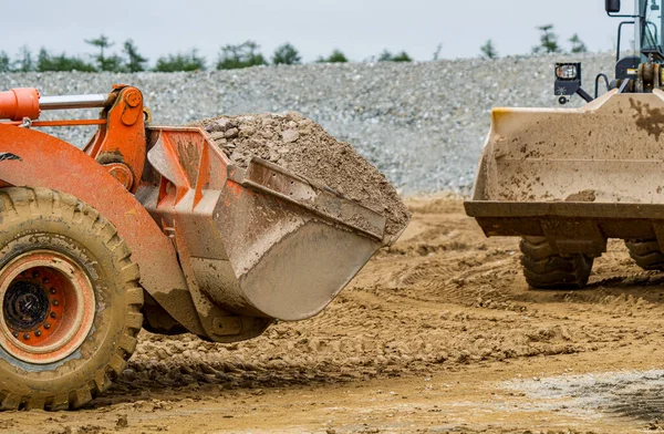 stock image Front end loader dumping stone and sand in a mining quarry. High quality photo
