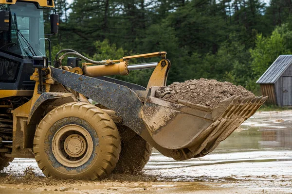 Front end loader dumping stone and sand in a mining quarry. High quality photo