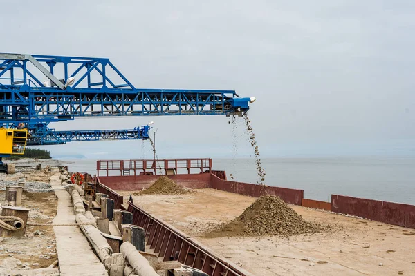 Industrial belt conveyor moving raw materials from mine. High quality photo