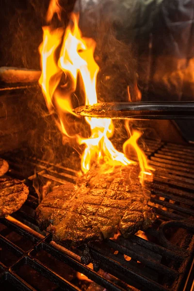 stock image Beef steak on the grill with flames. High quality photo