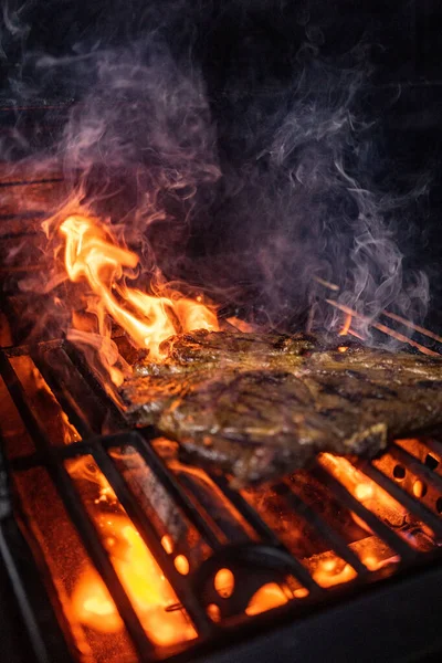 Beef steak on the grill with flames. High quality photo