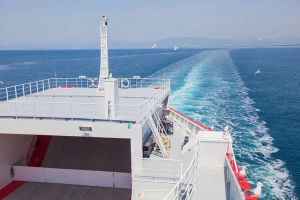 Beautiful view of the summer seascape from the ferryboat. Sea water waves trails. Greece summer travel destination.