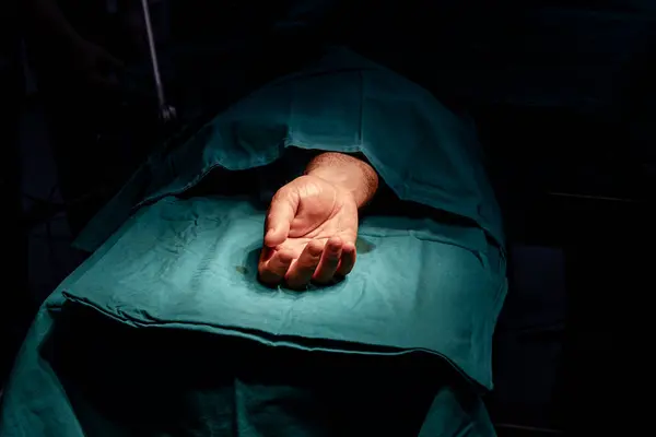 病人的手放在手术台上 准备在无菌手术室动手术 图库图片