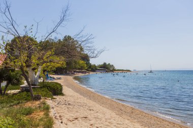 Sandy Shoreline ve Kristal berraklığında Sular ve Sahile Gidenler Günün tadını çıkarıyor