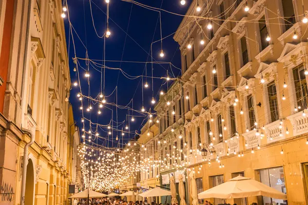 Avrupa 'nın tarihi bir caddesinin büyüleyici gece manzarası, yukarıdan çok sayıda dizili ışıkla güzelce aydınlatılmış binalarla dolu. Timisoara, Romanya.