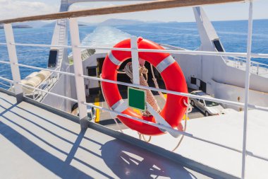 Kırmızı Hayat Halkası Güvenlik Ekipmanı Beyaz Feribot Güvertesinde Okyanus manzaralı ve Mavi Gökyüzü Deniz Taşımacılığı