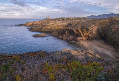 S'Arenella Lighthouse at Dusk as seen from the Coastal Path from Llanca to Port de la Selva, Catalonia clipart