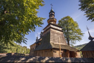 St. Paraskeva Orthodox Church in Kwiaton stands majestically under the sun, surrounded by nature, Poland clipart