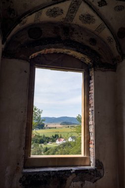 Looking out from Swiny Castle, the landscape unfolds with rolling hills and quaint homes below, Poland clipart